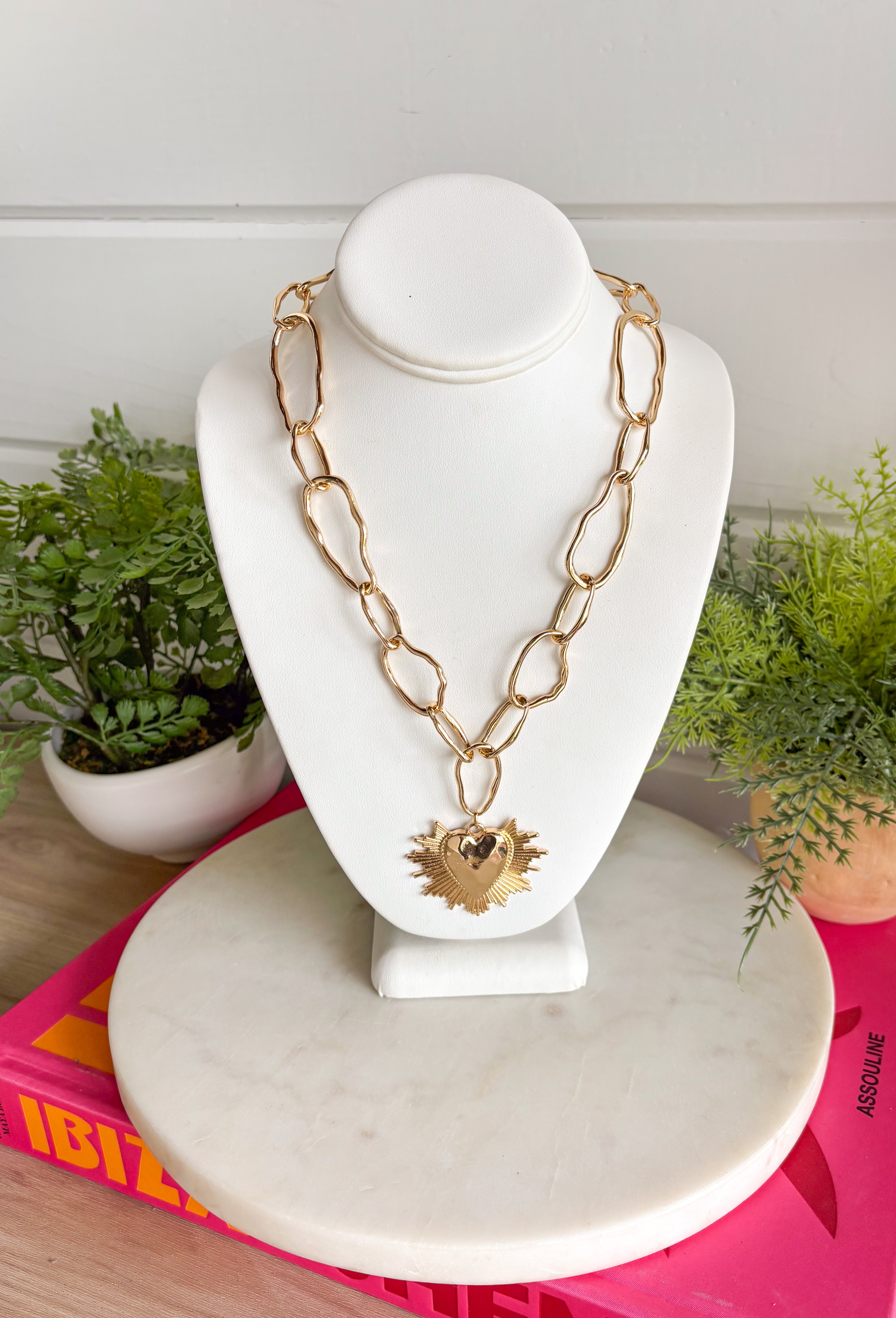 Simple, timeless, and full of charm! This gold open chain necklace features a textured gold heart pendant that adds a sweet and meaningful touch. The open link chain gives it a slightly modern feel while keeping the overall look classic and easy to style. Perfect for layering or wearing on its own, this necklace adds just the right amount of shine to any outfit. Whether paired with everyday basics or dressed up for a special occasion, it’s a versatile piece you’ll reach for again and again.