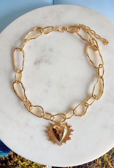 Simple, timeless, and full of charm! This gold open chain necklace features a textured gold heart pendant that adds a sweet and meaningful touch. The open link chain gives it a slightly modern feel while keeping the overall look classic and easy to style. Perfect for layering or wearing on its own, this necklace adds just the right amount of shine to any outfit. Whether paired with everyday basics or dressed up for a special occasion, it’s a versatile piece you’ll reach for again and again.