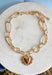Simple, timeless, and full of charm! This gold open chain necklace features a textured gold heart pendant that adds a sweet and meaningful touch. The open link chain gives it a slightly modern feel while keeping the overall look classic and easy to style. Perfect for layering or wearing on its own, this necklace adds just the right amount of shine to any outfit. Whether paired with everyday basics or dressed up for a special occasion, it’s a versatile piece you’ll reach for again and again.