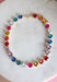 Add a meaningful touch of color to your jewelry collection with this beautiful cross necklace. Featuring a strand of colorful rhinestone crystals in shades of red, blue, green, pink, and gold, this eye-catching piece is finished with a matching cross pendant for the perfect blend of faith and style. The vibrant colors and delicate gold accents make it a standout accessory that's easy to wear for both everyday outfits and special occasions.