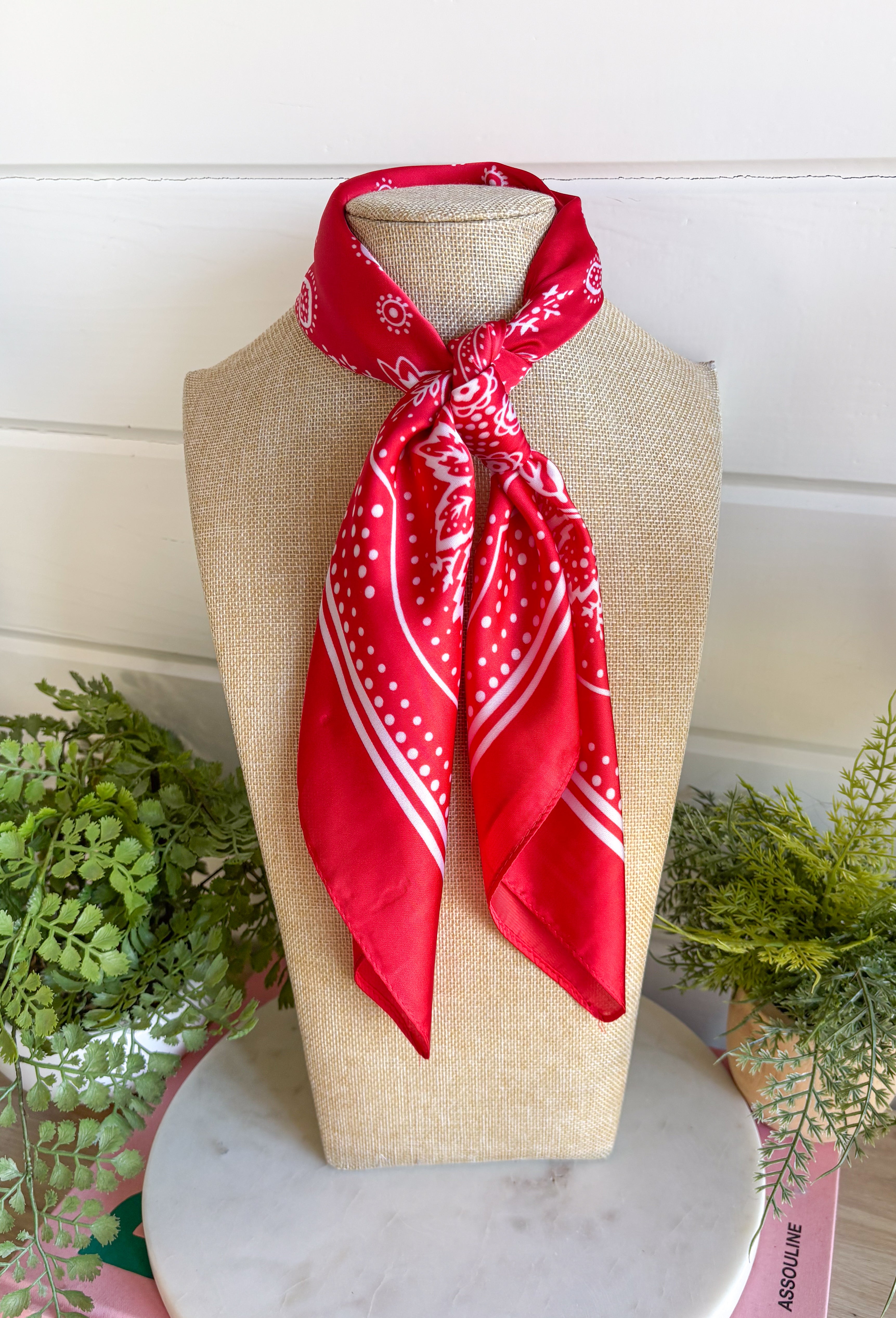 Add an easy western-inspired touch to your outfit with this red bandana neck scarf. The bold red color makes it a versatile accessory for fall while the soft material keeps it comfortable enough to wear all day long. Tie it around your neck for a classic bandana look, wear it as a headband, or knot it onto your favorite handbag for a fun pop of personality. From gameday and concerts to weekend plans and fall outings, there are plenty of ways to make this scarf your own.