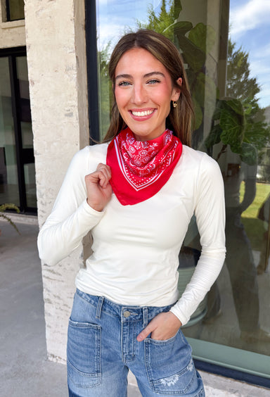 Add an easy western-inspired touch to your outfit with this red bandana neck scarf. The bold red color makes it a versatile accessory for fall while the soft material keeps it comfortable enough to wear all day long. Tie it around your neck for a classic bandana look, wear it as a headband, or knot it onto your favorite handbag for a fun pop of personality. From gameday and concerts to weekend plans and fall outings, there are plenty of ways to make this scarf your own.