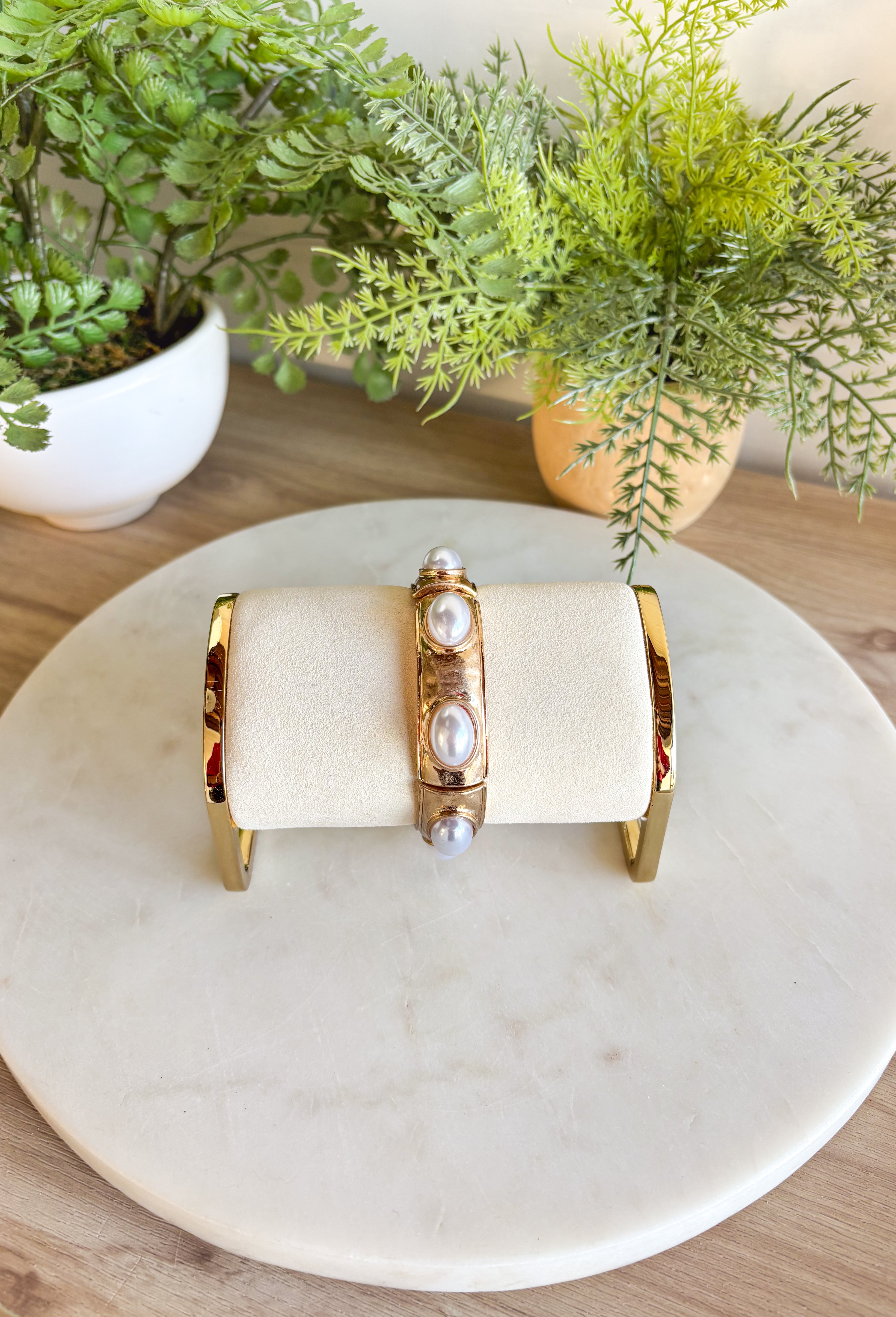 Add a touch of color and shine to your look with this gold bracelet featuring pearls all around. Designed in a pull-on style for easy wear, it’s lightweight, versatile, and the perfect finishing piece for both casual and dressier outfits. With its timeless mix of gold and pearls, this bracelet is one you’ll reach for season after season.