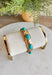 Add a touch of color and shine to your look with this gold bracelet featuring turquoise stones all around. Designed in a pull-on style for easy wear, it’s lightweight, versatile, and the perfect finishing piece for both casual and dressier outfits. With its timeless mix of gold and turquoise, this bracelet is one you’ll reach for season after season.