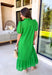 Soft, romantic, and perfect for spring, this green eyelet midi dress by Entro is a true seasonal favorite. The eyelet fabric adds beautiful texture while keeping the look light and airy, and the ruffled mock neck brings a sweet, vintage-inspired touch. Short puff sleeves and a ruffle hem give it an effortless flow, while the button-front closure adds classic charm. 