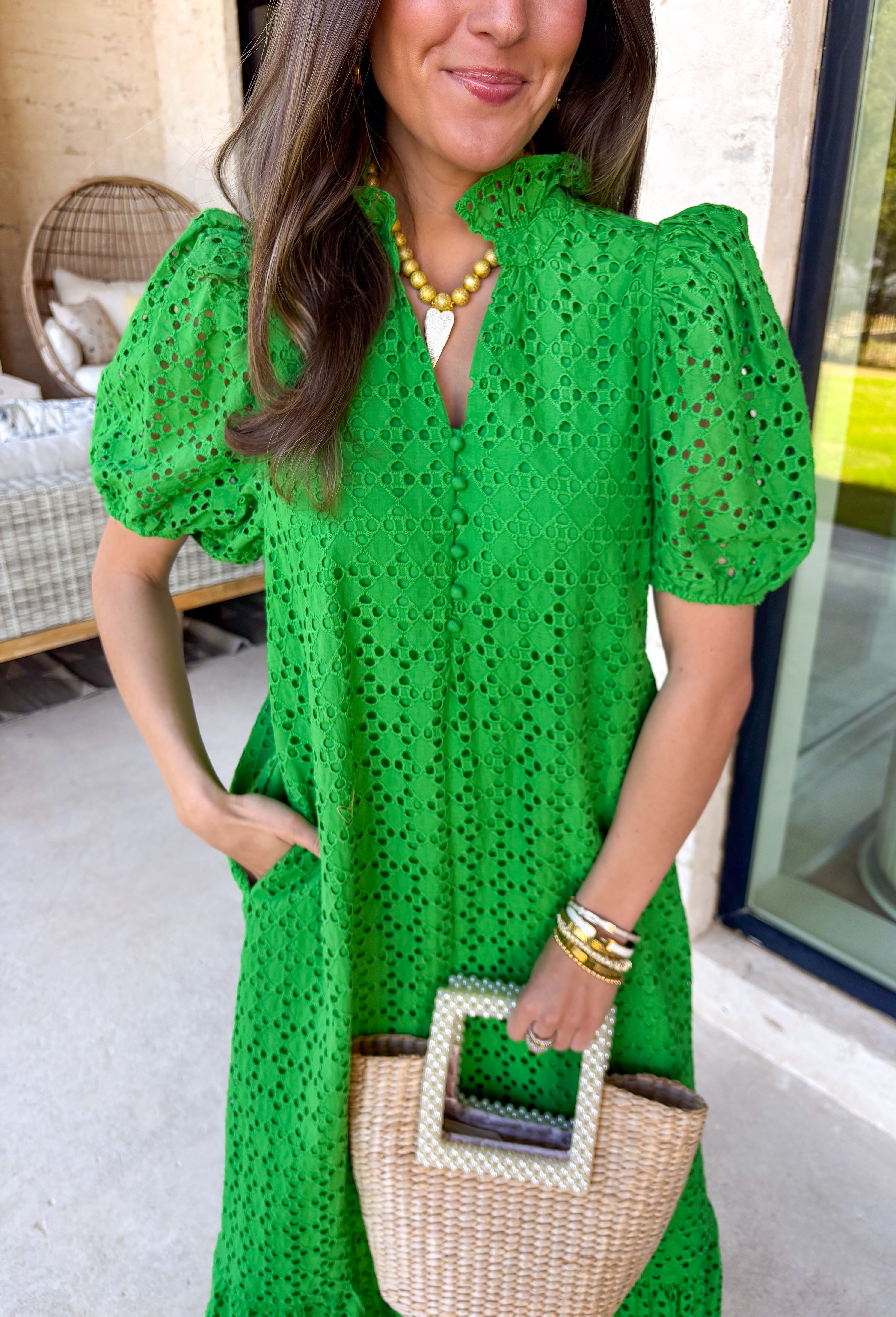 Soft, romantic, and perfect for spring, this green eyelet midi dress by Entro is a true seasonal favorite. The eyelet fabric adds beautiful texture while keeping the look light and airy, and the ruffled mock neck brings a sweet, vintage-inspired touch. Short puff sleeves and a ruffle hem give it an effortless flow, while the button-front closure adds classic charm. 