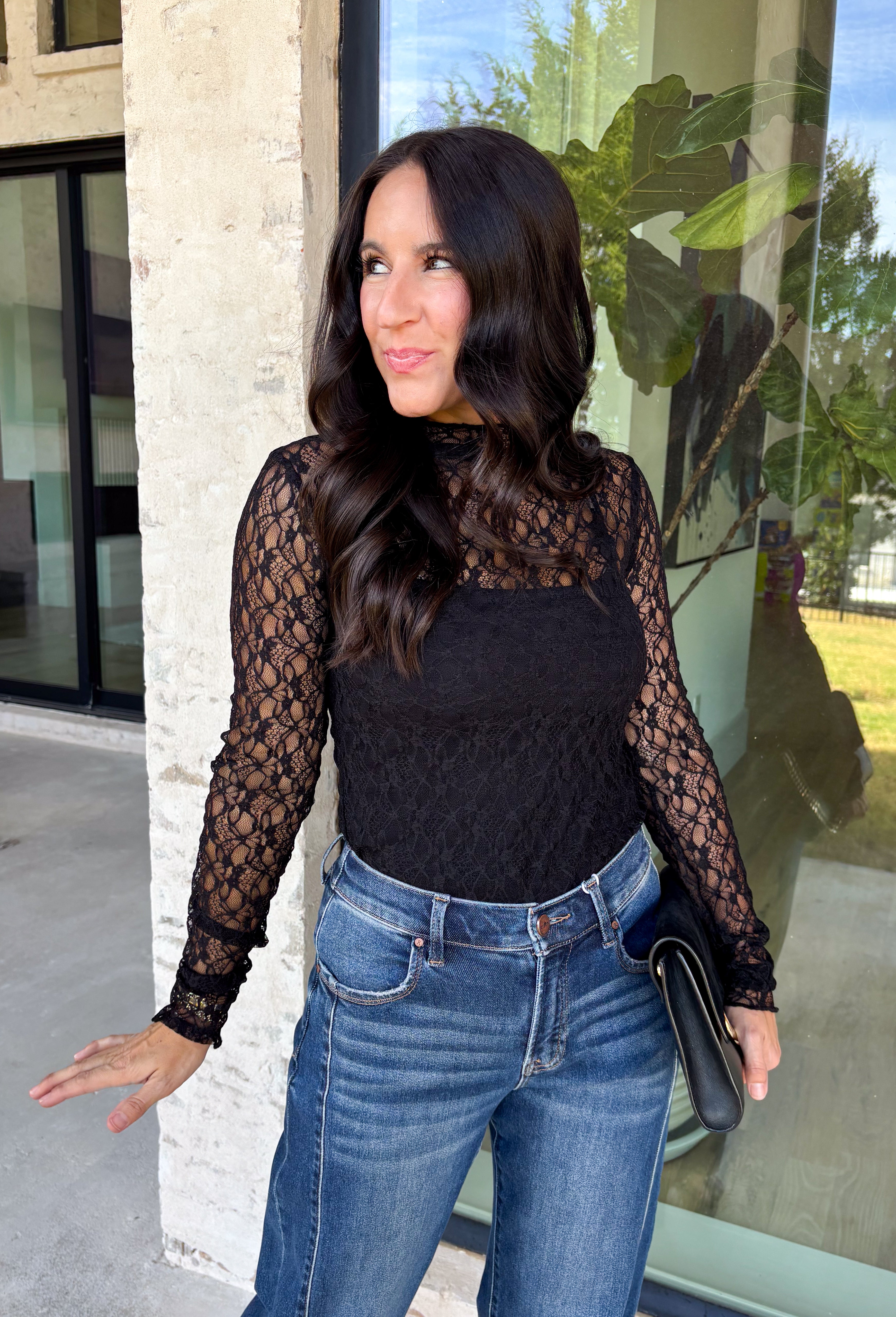 Meet the layering piece that adds a pretty touch to all your cooler-weather outfits. This black lace top from Hyfve features an allover lace design and mock neckline, giving even the simplest sweater, vest, or dress a little extra texture. The long sleeves are perfect for peeking out from underneath your favorite layers as the weather shifts from late fall into winter. A touch of spandex gives the fabric comfortable stretch, making it easy to wear underneath other pieces without adding bulky layers. 