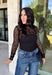 Meet the layering piece that adds a pretty touch to all your cooler-weather outfits. This black lace top from Hyfve features an allover lace design and mock neckline, giving even the simplest sweater, vest, or dress a little extra texture. The long sleeves are perfect for peeking out from underneath your favorite layers as the weather shifts from late fall into winter. A touch of spandex gives the fabric comfortable stretch, making it easy to wear underneath other pieces without adding bulky layers. 