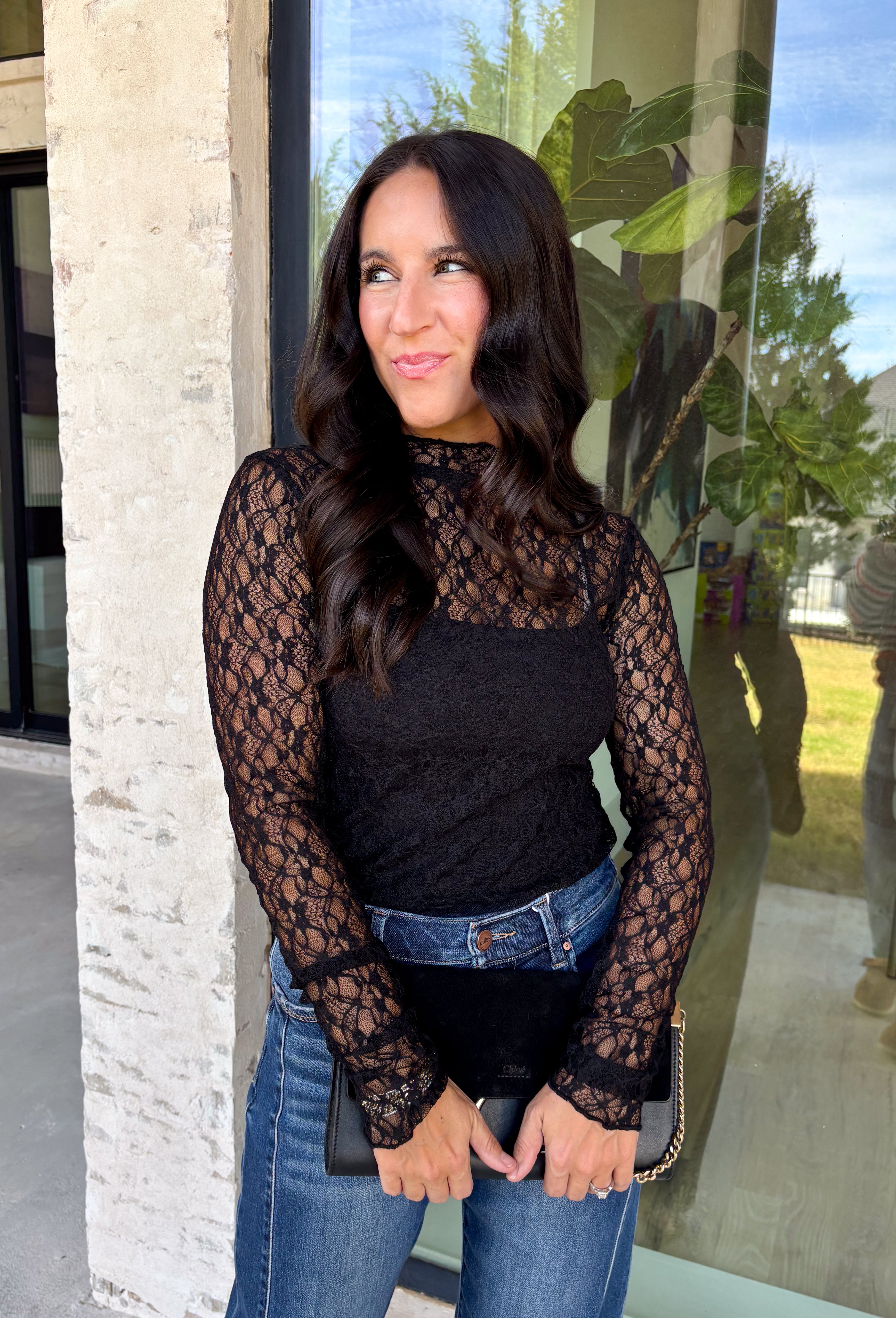 Meet the layering piece that adds a pretty touch to all your cooler-weather outfits. This black lace top from Hyfve features an allover lace design and mock neckline, giving even the simplest sweater, vest, or dress a little extra texture. The long sleeves are perfect for peeking out from underneath your favorite layers as the weather shifts from late fall into winter. A touch of spandex gives the fabric comfortable stretch, making it easy to wear underneath other pieces without adding bulky layers. 