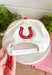 Bring a little western charm and plenty of personality to your everyday style with this fun trucker hat. Featuring a neutral front paired with a bold red bandana print bill, this standout accessory is embroidered with "Not Gonna Hold My Horses" across the front in vibrant red stitching. The side is finished with "Half Past Yee-Haw" embroidery, while a red embroidered horseshoe on the back adds the perfect finishing touch. 