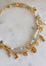 This layered necklace gives you that perfectly styled, on-trend look without any effort! Featuring a neutral beaded strand with gold accents paired with a charm-filled gold chain, it brings the perfect mix of western-inspired and playful details. With charms like a cross, heart, palm leaf, bow, and even a shoe, it adds so much personality to your outfit. Lightweight and easy to wear, it’s the ultimate throw-on accessory for summer days when you want to look put together in seconds. 