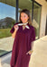 Effortless and versatile, this burgundy midi dress is an easy favorite for fall. Designed with a band collar v-neckline and elasticated short sleeves, it offers both structure and comfort. Side pockets keep it practical, while the soft, stretchy fabric blend makes it perfect for all-day wear. You'll find yourself reaching for this dress all season long!