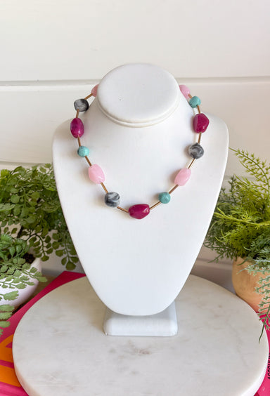 Add the perfect finishing touch to your outfit with this beautifully detailed beaded necklace! Featuring pink, turquoise, marble, and raspberry beads separated by shimmering gold accents, this timeless piece brings just the right amount of color and elegance to your jewelry collection. The 18K gold-dipped finish gives it a polished look that's easy to wear from everyday outings to special occasions, making it a versatile accessory you'll reach for season after season.