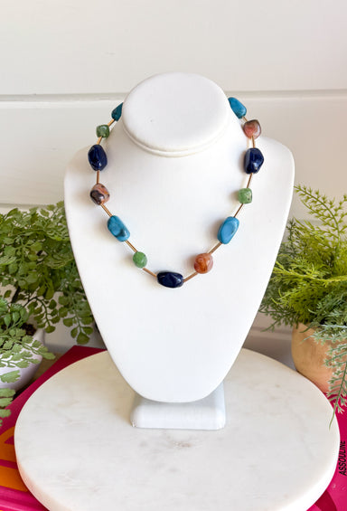 Add the perfect finishing touch to your outfit with this beautifully detailed beaded necklace! Featuring turquoise, green, brown, and navy beads separated by shimmering gold accents, this timeless piece brings just the right amount of color and elegance to your jewelry collection. The 18K gold-dipped finish gives it a polished look that's easy to wear from everyday outings to special occasions, making it a versatile accessory you'll reach for season after season.
