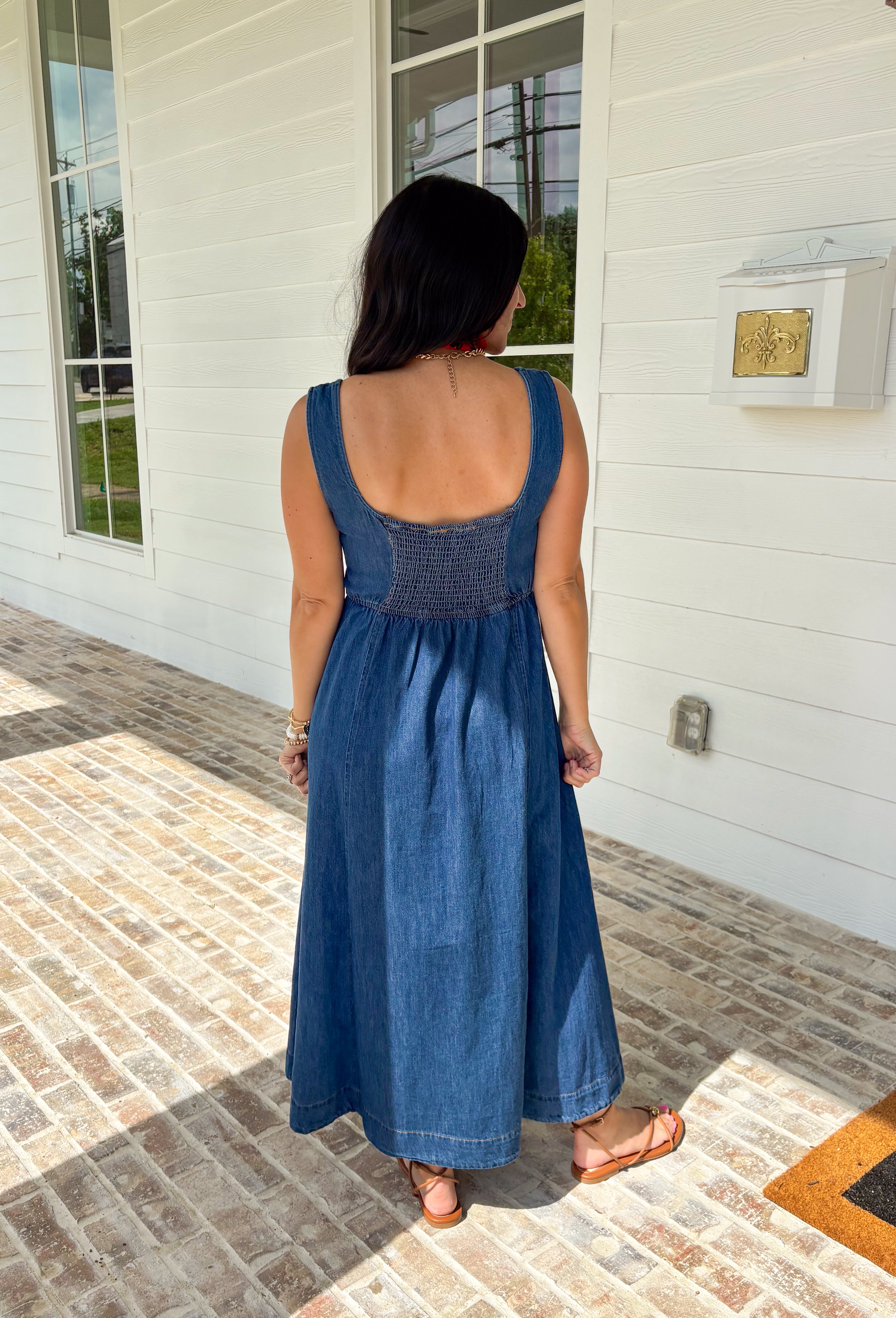 This dark wash sleeveless midi dress is the kind of effortless staple you’ll reach for all summer long! The rich denim wash gives it a slightly elevated feel, while the pleating along the front adds a soft, flattering detail. The smocked back keeps the fit comfortable and easy, making it perfect for all-day wear. Lightweight and breathable in 100% cotton, it’s ideal for everything from casual days to dinner plans. 
