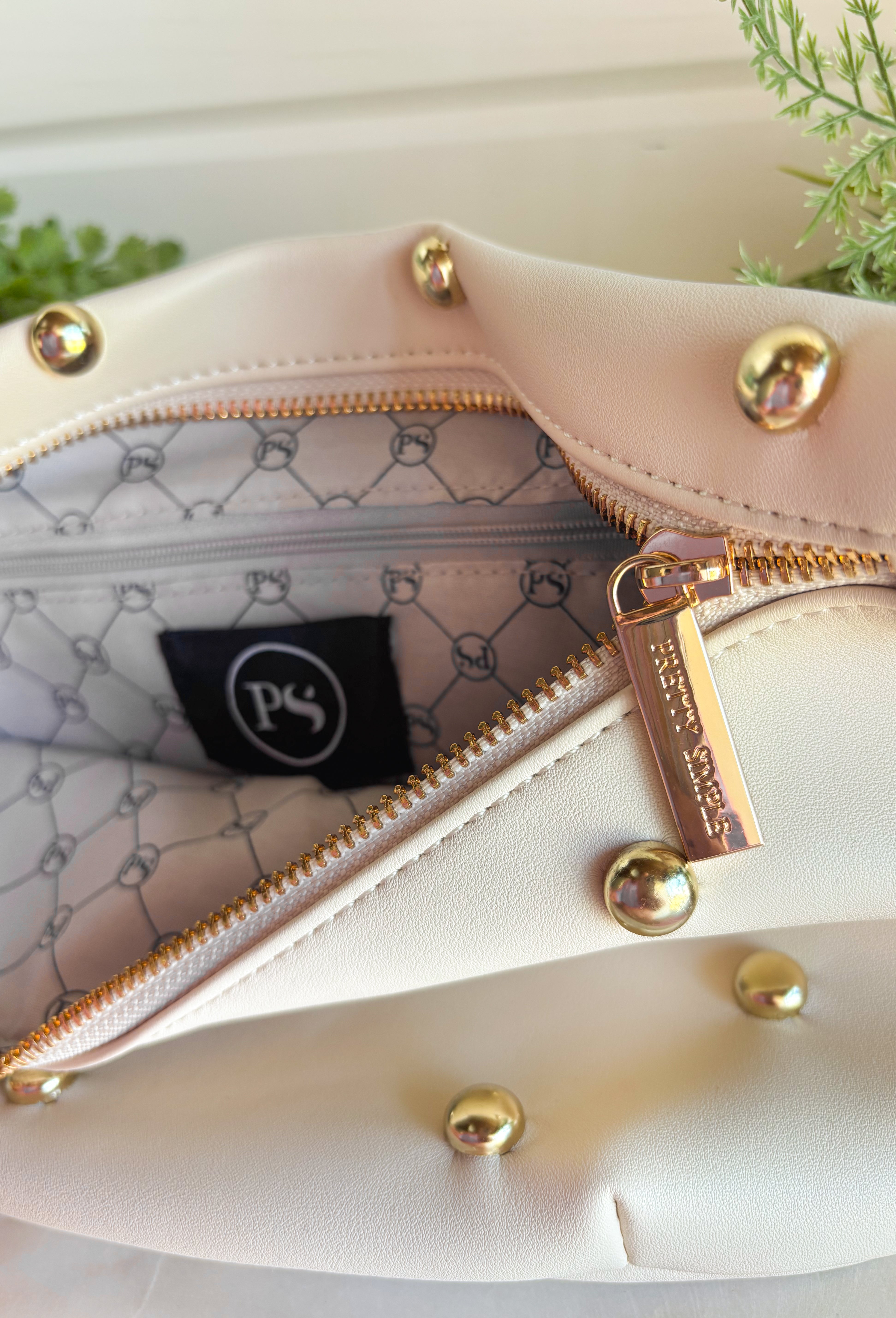 Everyone's favorite bag is back in a bold new design! The Studded Westlyn Bum Bag from Pretty Simple features the same hands-free style you love, now updated with eye-catching gold stud detailing for the perfect touch of edge. Crafted from soft vegan leather, this versatile bag can be worn as a belt bag or crossbody, making it the perfect companion for busy days, concerts, travel, shopping, and everyday adventures. Stylish, functional, and easy to wear, it's sure to become your new go-to accessory.