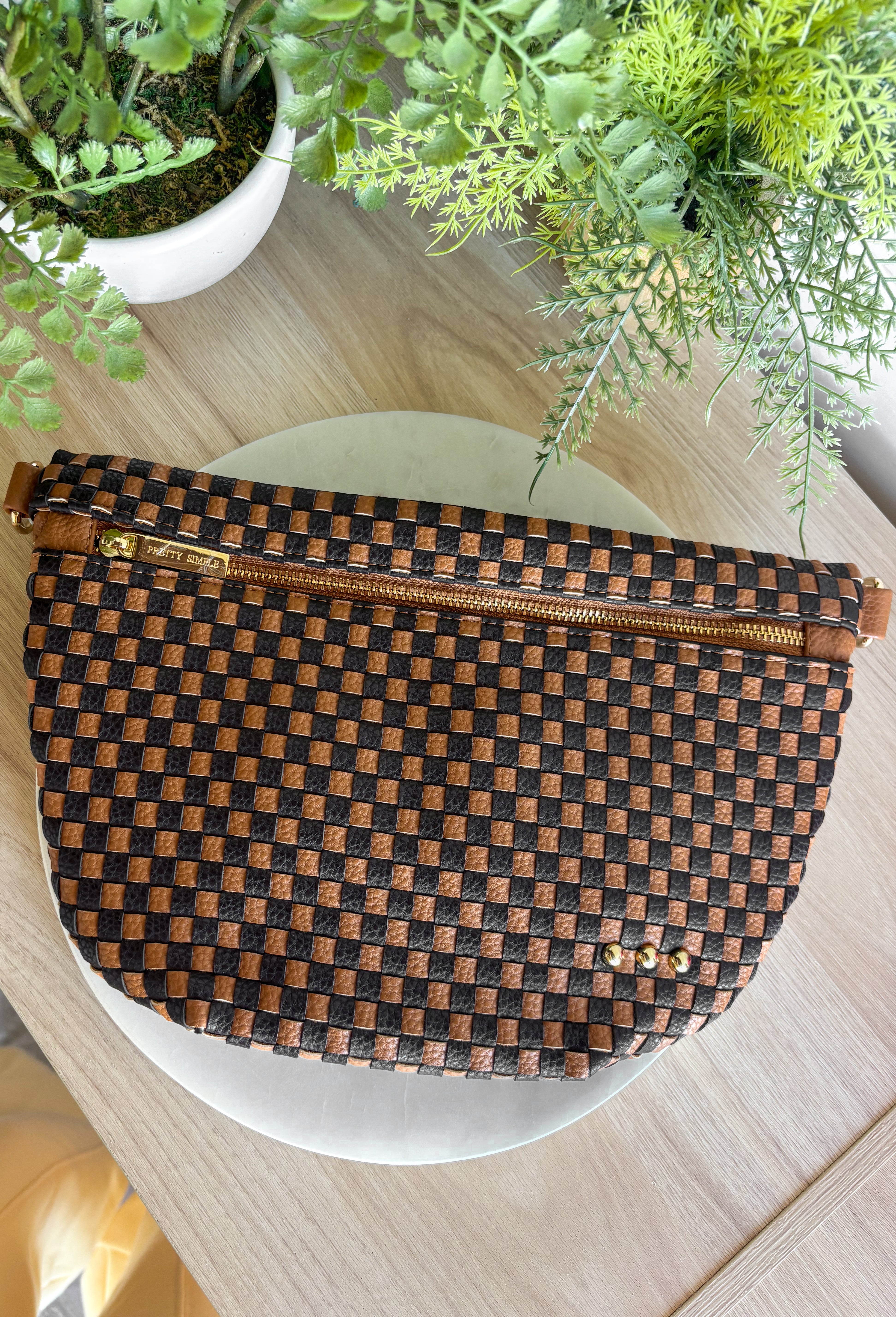 Meet the Westlyn&nbsp;Woven Bum Bag! Gorgeous woven vegan leather available in solid colors with a unique block design on the strap gives us edgy, rocker vibes. We also have it available in checkered prints, and metallic! Beautiful hardware with a zipper closure with beige and black chevron interior, and a zippered slash pocket on the inside. This crossbody bag is the perfect accessory to elevate any outfit!