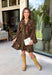Feminine, chic, and full of seasonal charm, this floral dress is the perfect piece for all your favorite fall occasions. Featuring a classic brown backdrop with a vibrant colorful floral print, this dress offers a timeless silhouette with eye-catching details. The flattering v-neckline is accented by a beautiful scarf tie that adds a polished, sophisticated touch, while the self-tie waist creates a customizable fit you'll love. 