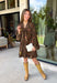 Feminine, chic, and full of seasonal charm, this floral dress is the perfect piece for all your favorite fall occasions. Featuring a classic brown backdrop with a vibrant colorful floral print, this dress offers a timeless silhouette with eye-catching details. The flattering v-neckline is accented by a beautiful scarf tie that adds a polished, sophisticated touch, while the self-tie waist creates a customizable fit you'll love. 