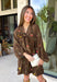 Feminine, chic, and full of seasonal charm, this floral dress is the perfect piece for all your favorite fall occasions. Featuring a classic brown backdrop with a vibrant colorful floral print, this dress offers a timeless silhouette with eye-catching details. The flattering v-neckline is accented by a beautiful scarf tie that adds a polished, sophisticated touch, while the self-tie waist creates a customizable fit you'll love. 