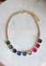Add a vibrant finishing touch to your jewelry collection with this stunning gold chain necklace. Featuring colorful gemstones in shades of green, blue, gold, pink, red, and burgundy, this chic piece brings the perfect balance of timeless style and playful color. The delicate gold chain makes it easy to wear on its own or layered with your favorite necklaces, creating an effortlessly polished look for any occasion.