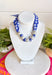 Add a fresh twist to your accessory collection with this versatile scarf necklace that's full of timeless charm. Featuring a beautiful blue and white floral print on one side and a classic blue and white gingham print on the reverse, this unique piece lets you switch up your look with ease. Chunky pearl detailing adds a chic touch, while the scarf tie design allows you to adjust the fit exactly how you like it. 