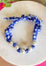 Add a fresh twist to your accessory collection with this versatile scarf necklace that's full of timeless charm. Featuring a beautiful blue and white floral print on one side and a classic blue and white gingham print on the reverse, this unique piece lets you switch up your look with ease. Chunky pearl detailing adds a chic touch, while the scarf tie design allows you to adjust the fit exactly how you like it. 