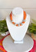 Add a playful pop of autumn color to your accessory collection with this versatile scarf necklace that's full of timeless charm. Featuring a cheerful orange polka dot print accented with brown and light pink trim, this unique piece is finished with chunky pearl detailing for a chic touch. The scarf tie design allows you to adjust the fit exactly how you like it, making it easy to wear as a necklace or wrap around your wrist as a chic bracelet. 