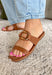 These cognac brown slide sandals are the effortless finishing touch every summer outfit needs! Designed with a sleek silhouette and gold oval buckle detail, they bring just the right amount of polish while still keeping things easy and wearable. The neutral tone makes them incredibly versatile—perfect for pairing with everything from dresses to denim. Whether you're heading to brunch, running errands, or packing for vacation, these slides are a go-to for any occasion. 