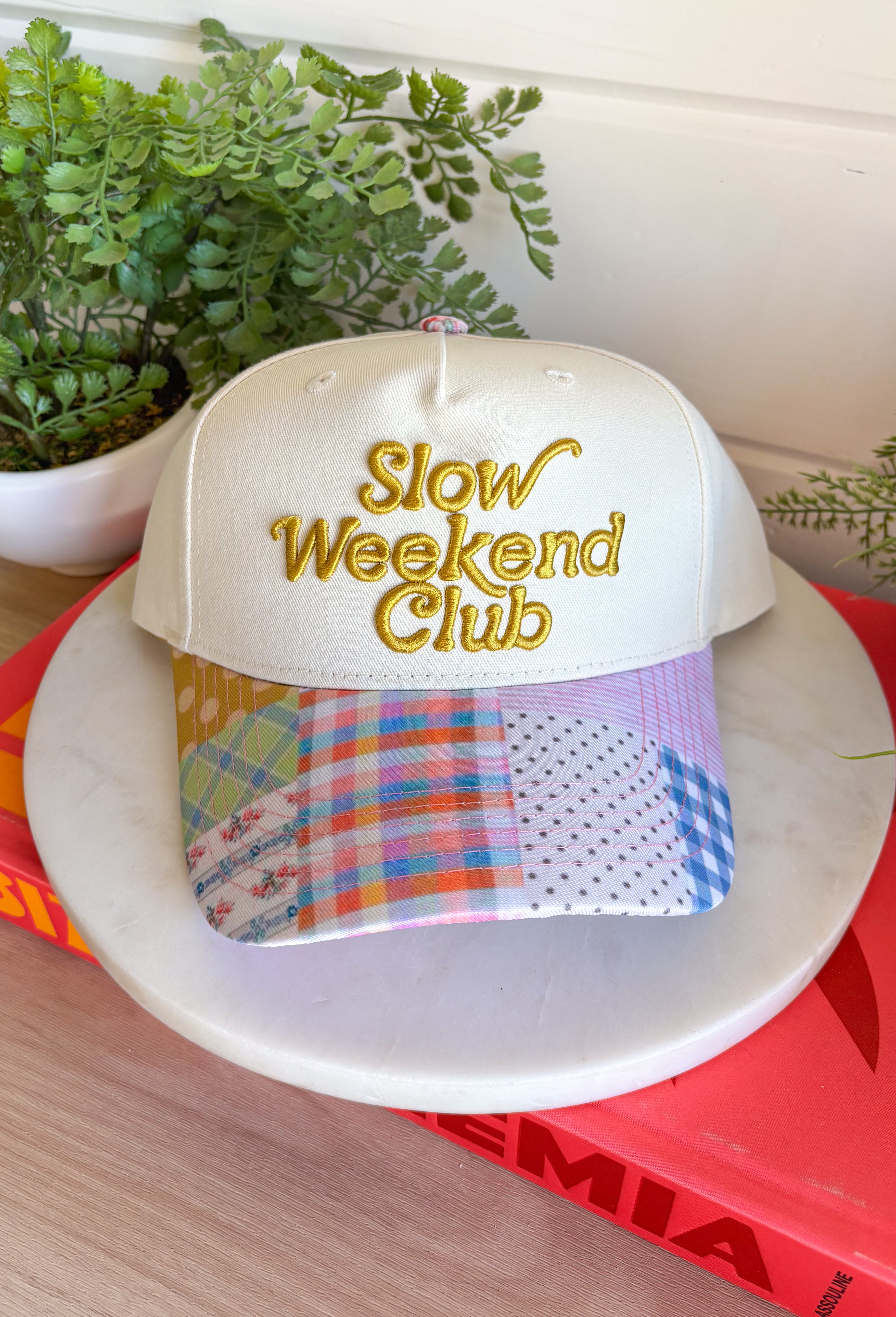 This “Slow Weekend Club” trucker hat is all about those laid-back summer moments! With olive embroidery on a neutral base, it keeps things easy and versatile, while the colorful patchwork bill adds the most fun, unexpected pop. Even better—each hat features a unique patchwork design, so no two are exactly alike. It’s playful, relaxed, and made for coffee runs, errands, or those slower days you actually get to enjoy. Throw it on and lean into those easy weekend vibes—add it to your cart now!