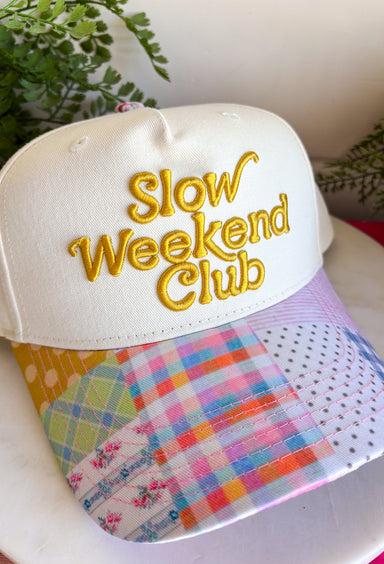 This “Slow Weekend Club” trucker hat is all about those laid-back summer moments! With olive embroidery on a neutral base, it keeps things easy and versatile, while the colorful patchwork bill adds the most fun, unexpected pop. Even better—each hat features a unique patchwork design, so no two are exactly alike. It’s playful, relaxed, and made for coffee runs, errands, or those slower days you actually get to enjoy. Throw it on and lean into those easy weekend vibes—add it to your cart now!