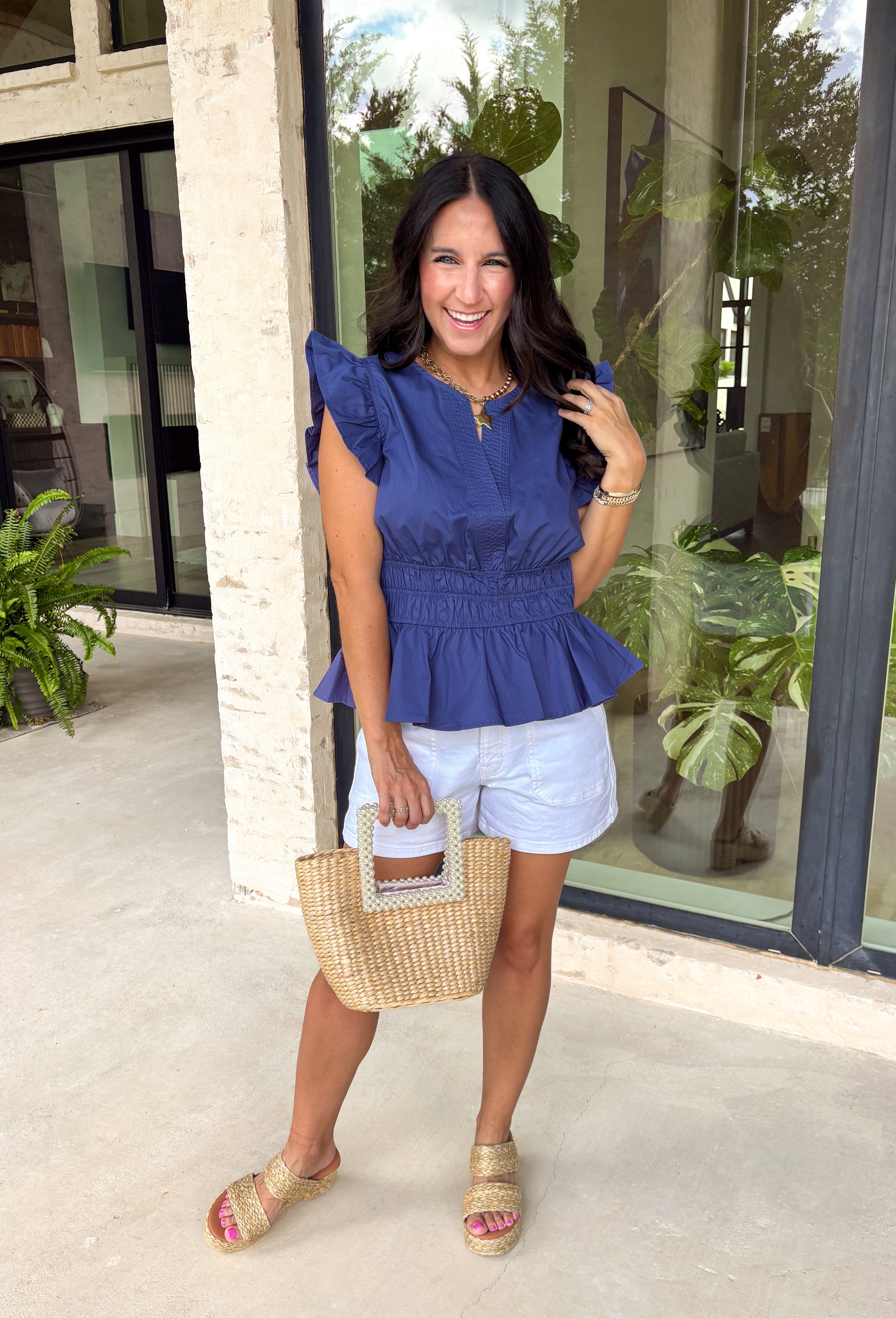 This navy top is such a timeless staple for your summer wardrobe! The rich color feels classic and easy to style, while the elastic waist creates a flattering, effortless shape that’s comfortable for all-day wear. The ruffle sleeves add a soft, feminine touch, and the v-neckline keeps it light and breezy for warm days. Made from breathable cotton, it’s perfect for everything from casual outings to lunch with friends.