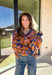 Brighten up your winter wardrobe with this bold camel sweater by Fate, featuring an eye-catching leopard print in shades of brown, pink, and blue. The striped collar and neckline add a fun, sporty touch while the soft knit keeps things cozy and comfortable for chilly days. It’s the perfect statement sweater for adding color and personality to your cold-weather lineup.