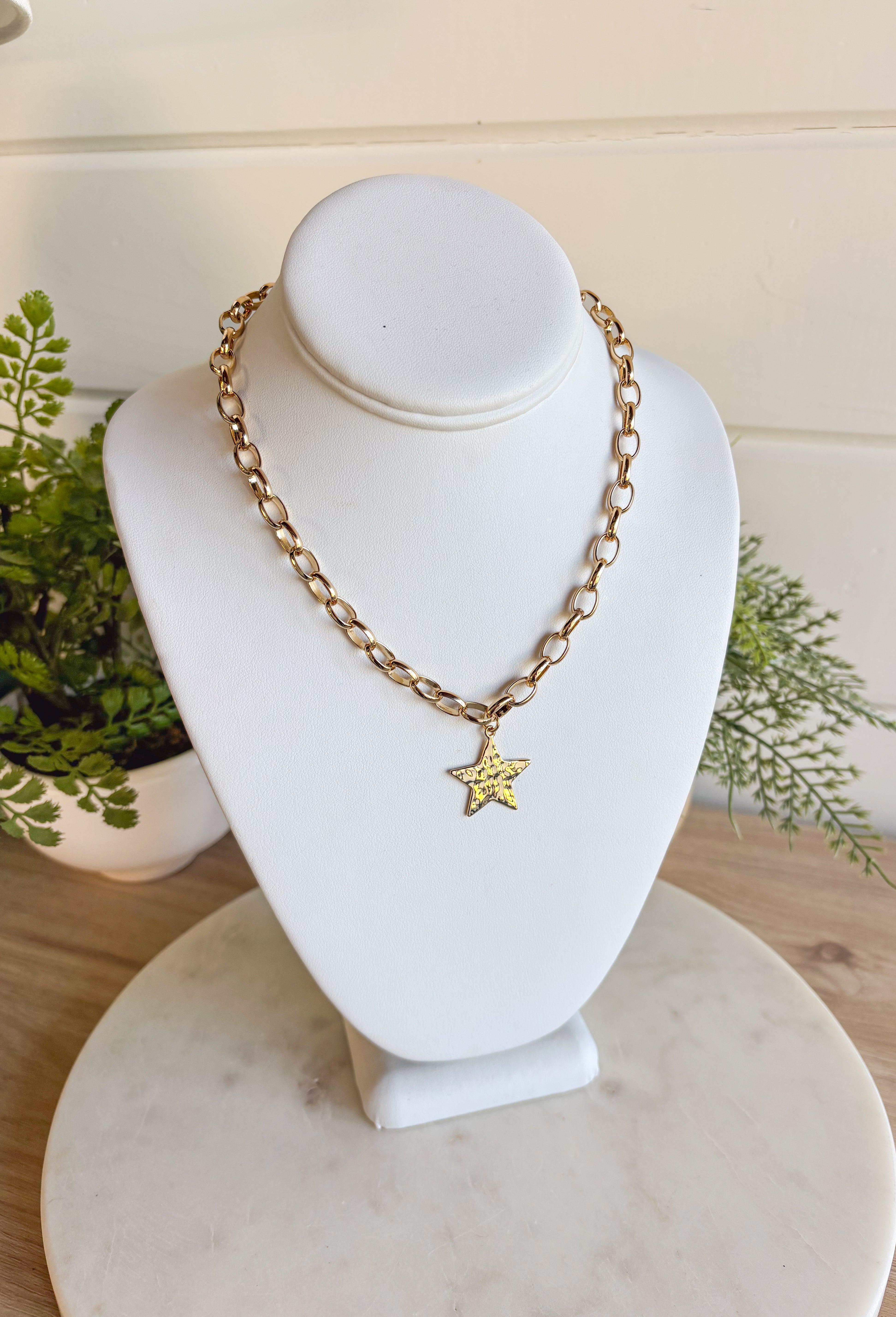Simple and chic, this gold chain necklace is finished with a hammered star charm for just the right touch of texture. Measuring 16" in length, it’s the perfect everyday piece to wear solo or layered with other necklaces. Lightweight and versatile, it adds a hint of shine that works year-round.