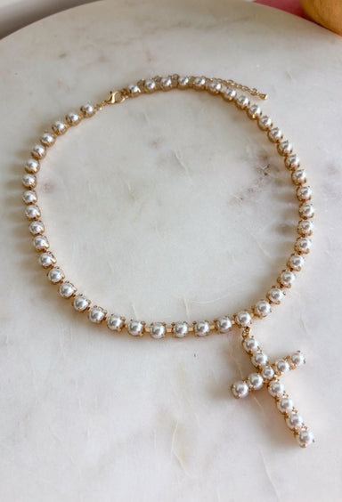 Classic pearls and a meaningful touch come together in this beautiful necklace from Blanche &amp; Co. The gold chain is accented with pearls throughout, creating a timeless look with just the right amount of shine. A pearl cross pendant serves as the centerpiece, adding a sweet expression of faith to the design. Wear it as an everyday reminder or save it for church, celebrations, and special occasions when you want something classic and meaningful.