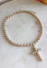 Classic pearls and a meaningful touch come together in this beautiful necklace from Blanche &amp; Co. The gold chain is accented with pearls throughout, creating a timeless look with just the right amount of shine. A pearl cross pendant serves as the centerpiece, adding a sweet expression of faith to the design. Wear it as an everyday reminder or save it for church, celebrations, and special occasions when you want something classic and meaningful.