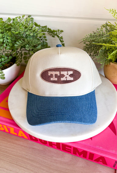 Simple, timeless, and full of Texas pride! This neutral trucker hat is the perfect everyday accessory for anyone who loves the Lone Star State. Featuring a brown embroidered patch outlined in tan with a bold "TX" design, it pairs effortlessly with everything from graphic tees to cozy sweatshirts. The denim bill adds a laid-back touch, while the adjustable back ensures a comfortable fit for all-day wear.