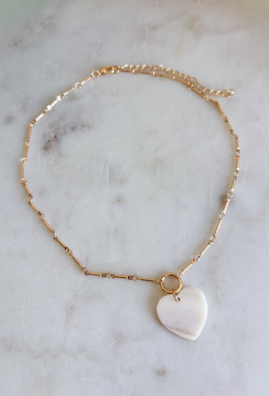 This dainty gold chain necklace with a mother of pearl heart charm is the definition of effortless spring style! It has that soft, luminous glow that instantly elevates your everyday look while still feeling simple and wearable. The delicate chain makes it perfect for layering, while the heart charm adds a timeless, feminine touch you’ll reach for again and again. Add this classic beauty to your jewelry rotation—you’ll wear it nonstop!