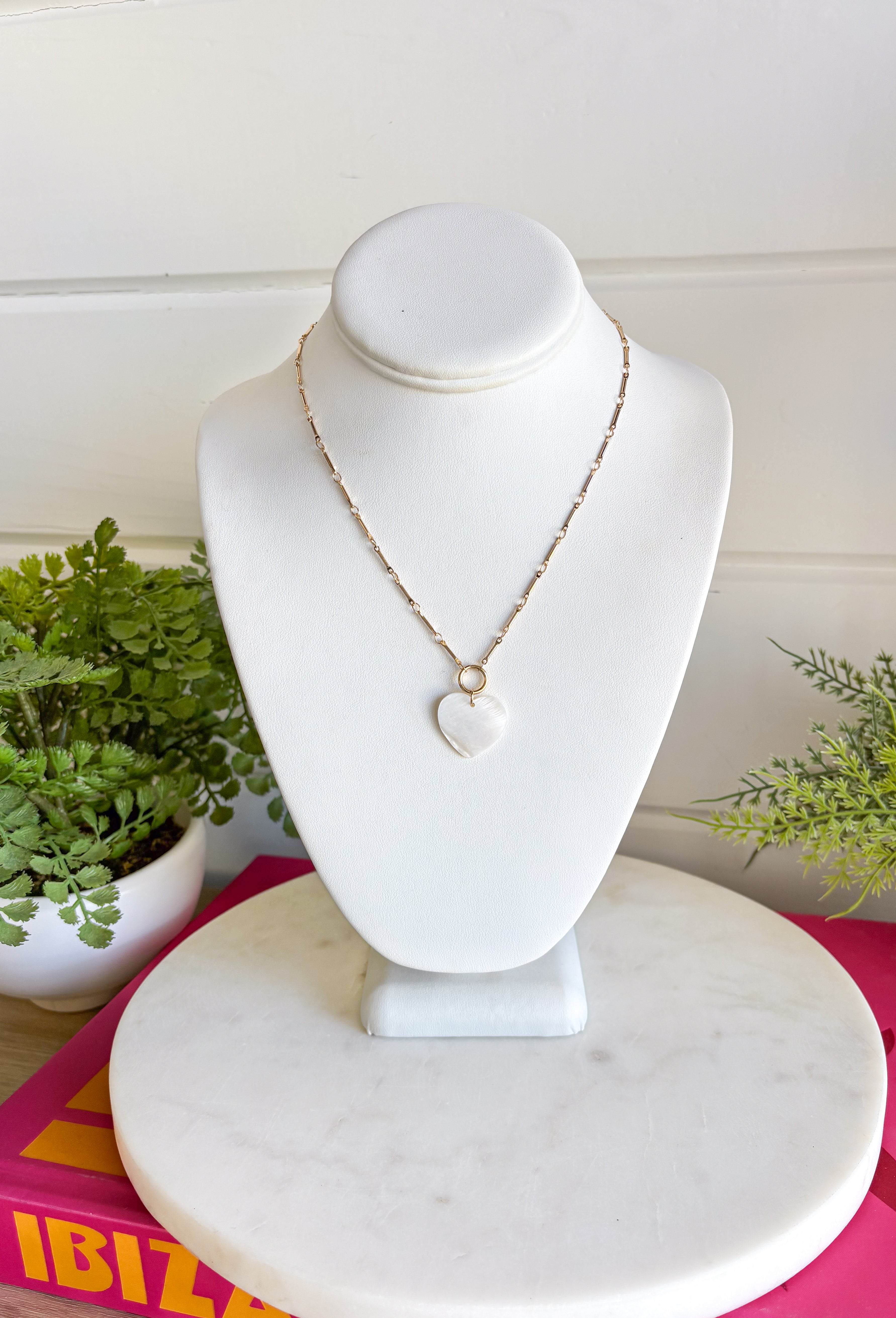 This dainty gold chain necklace with a mother of pearl heart charm is the definition of effortless spring style! It has that soft, luminous glow that instantly elevates your everyday look while still feeling simple and wearable. The delicate chain makes it perfect for layering, while the heart charm adds a timeless, feminine touch you’ll reach for again and again. Add this classic beauty to your jewelry rotation—you’ll wear it nonstop!