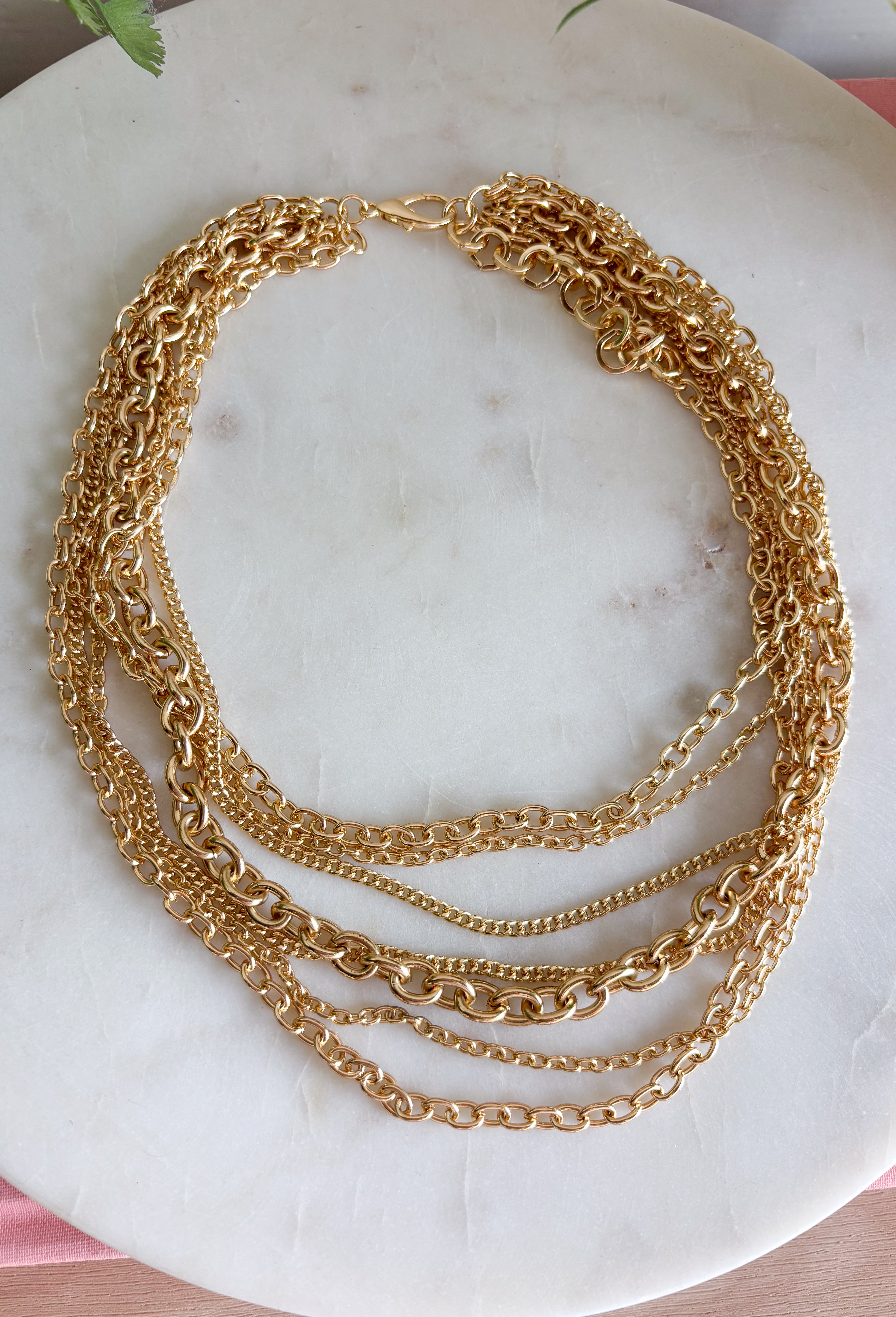 Get the layered look without having to mix and match with this gold chain necklace from Garden Party. Multiple chains come together in one easy piece, giving you that perfectly stacked look with none of the guesswork. The classic gold finish makes it simple to pair with everything from everyday basics to dressier outfits. It’s an easy grab-and-go accessory when your outfit needs a little extra shine.