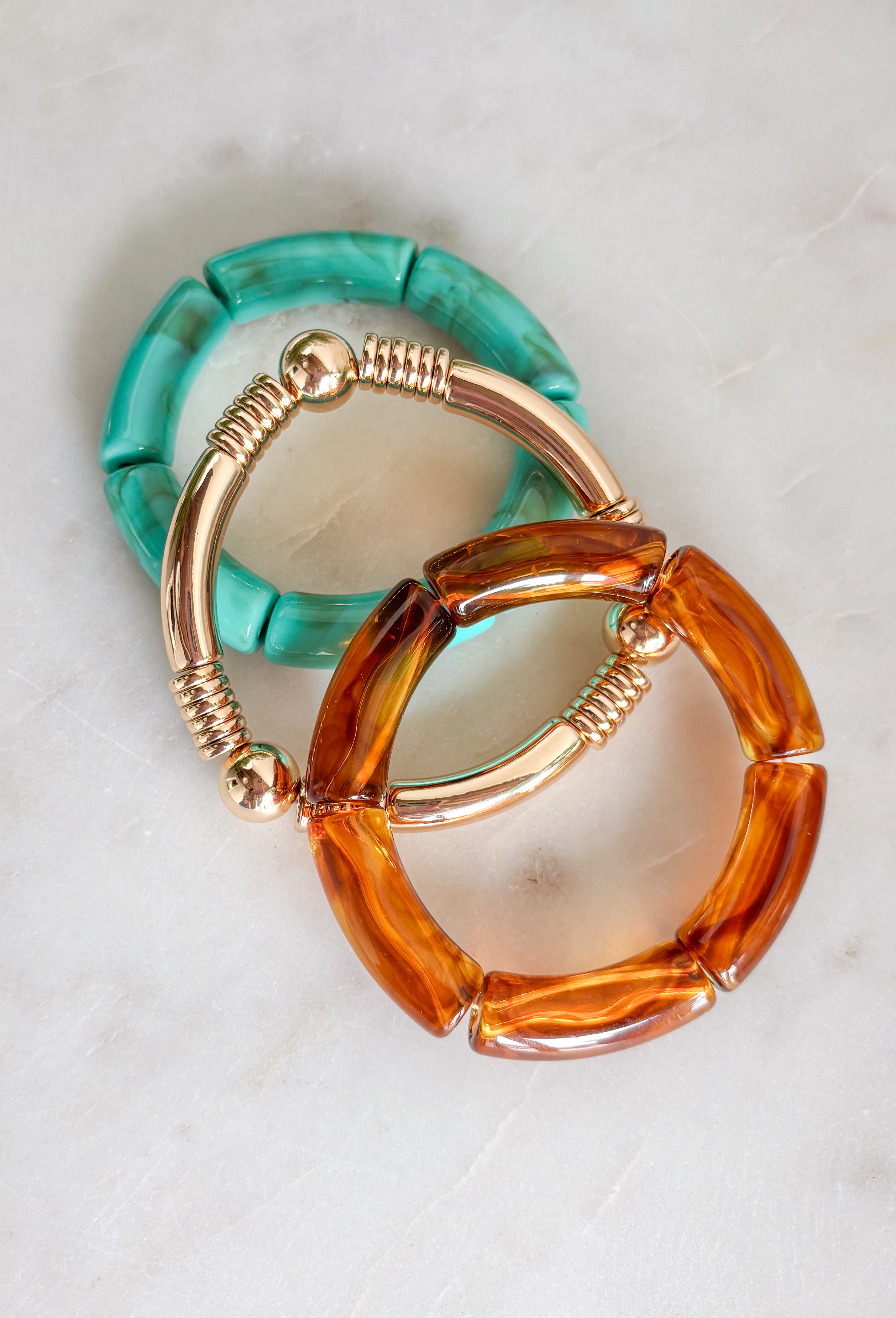 This set of three bracelets is the easiest way to add a little extra to your summer look! Blending turquoise beads, classic gold, and tortoise shell, this set creates an effortlessly styled, perfectly layered look. The mix of textures and tones makes it super versatile—easy to wear with everything from casual outfits to more dressed-up looks. Just slip them on and go for an instant accessory upgrade. Whether you're heading out for the day or packing for vacation, this set is a go-to. 