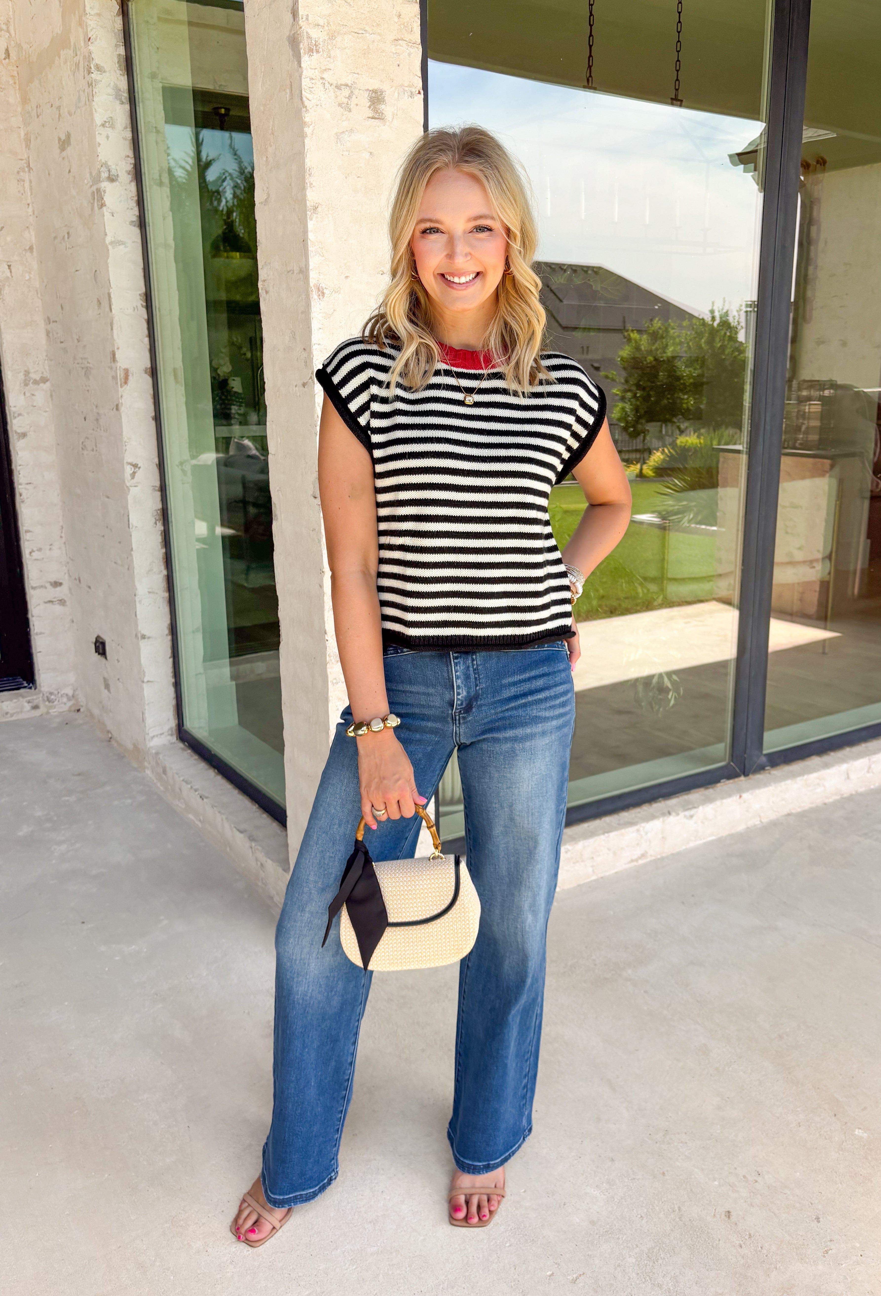 Timeless stripes get a fun seasonal update in this cozy short sleeve sweater. Featuring classic black and white stripes with a bold red contrast neckline, this knit is the perfect blend of classic and playful. The soft, cozy fabric makes it ideal for crisp fall mornings and cool evenings, while the short sleeves make layering effortless under jackets, and blazers. 
