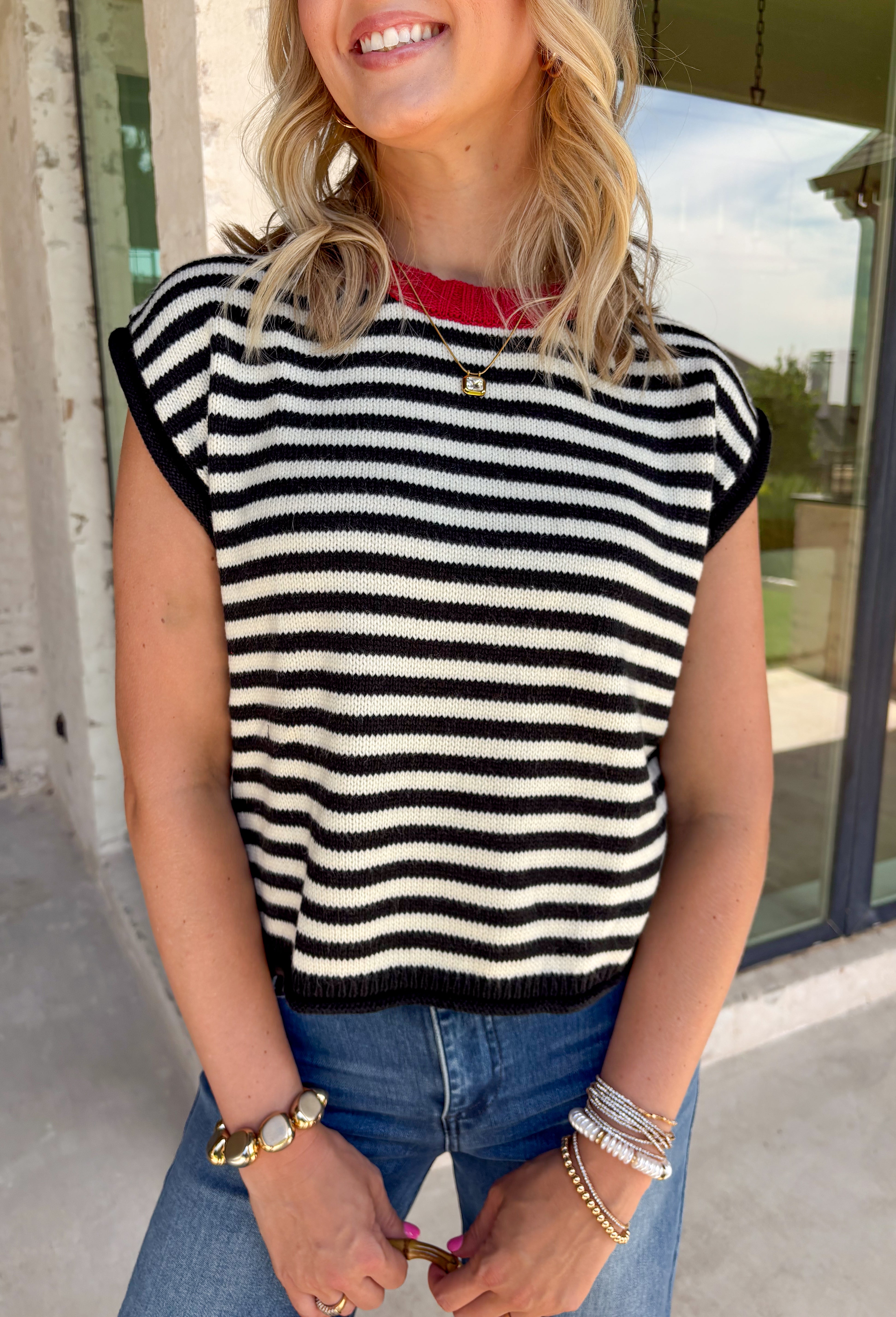 Timeless stripes get a fun seasonal update in this cozy short sleeve sweater. Featuring classic black and white stripes with a bold red contrast neckline, this knit is the perfect blend of classic and playful. The soft, cozy fabric makes it ideal for crisp fall mornings and cool evenings, while the short sleeves make layering effortless under jackets, and blazers. 