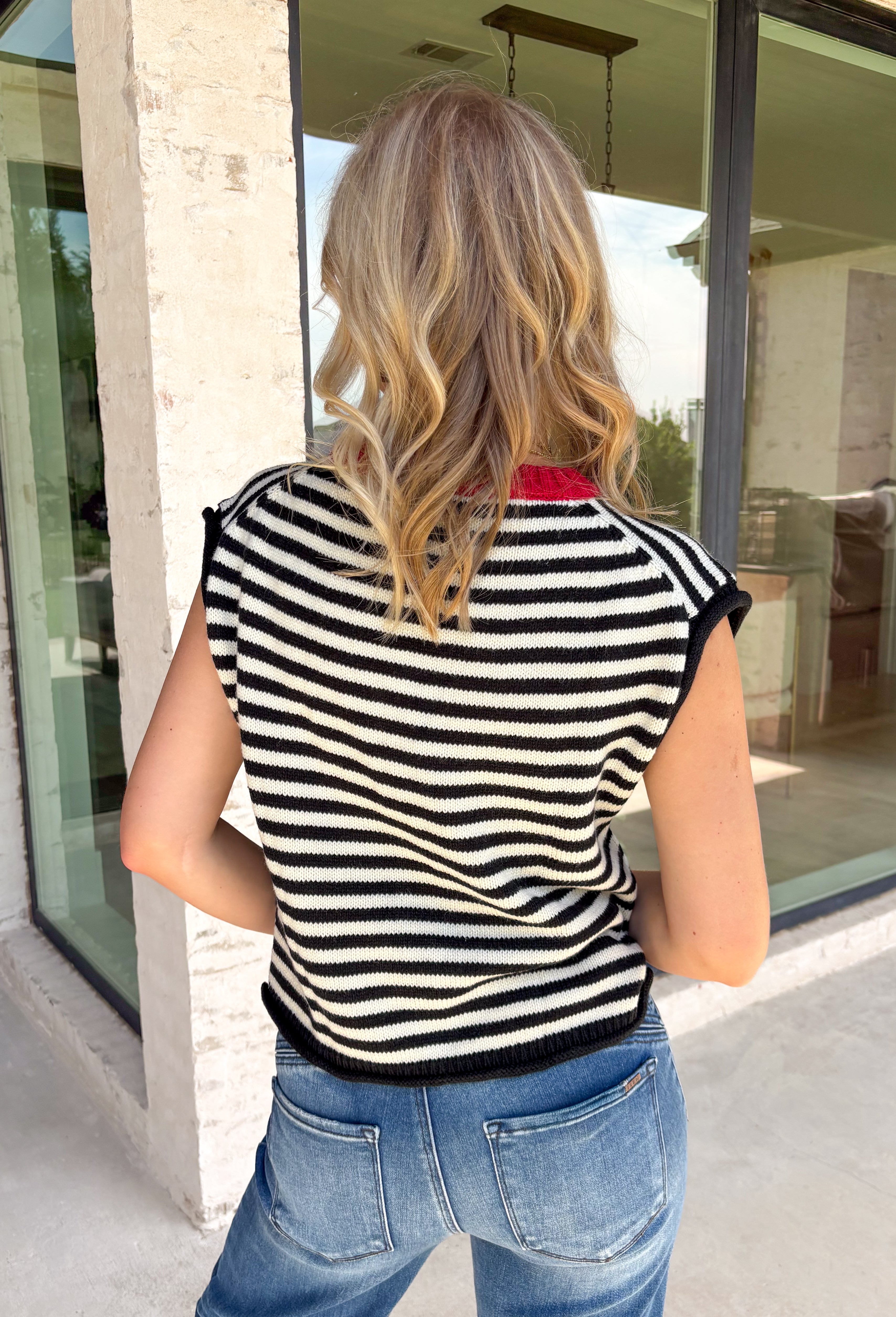 Timeless stripes get a fun seasonal update in this cozy short sleeve sweater. Featuring classic black and white stripes with a bold red contrast neckline, this knit is the perfect blend of classic and playful. The soft, cozy fabric makes it ideal for crisp fall mornings and cool evenings, while the short sleeves make layering effortless under jackets, and blazers. 