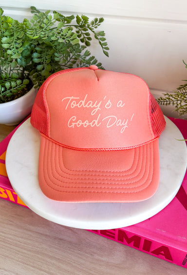 This coral trucker hat is your new go-to reminder to keep things light and positive! With its monochromatic “Today’s A Good Day” design, it’s simple, uplifting, and easy to style with all your summer outfits. The breathable mesh back keeps it cool for those hot, on-the-go days, while the adjustable fit makes it comfortable for all-day wear. Whether you're heading out for errands, a walk, or just enjoying some sunshine, this hat adds the perfect feel-good touch. Go ahead—throw it on and make it a good day!