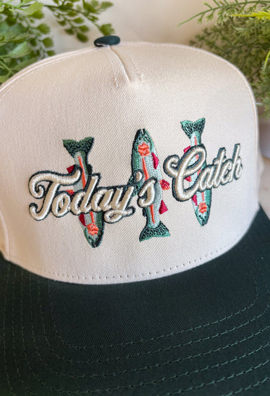 Whether you're headed to the lake, spending the day outdoors, or just love a playful graphic accessory, this trucker hat from The Happiest is the perfect finishing touch. Featuring a neutral crown with a hunter green bill, this hat is embroidered with "Today's Catch" and a colorful fish design in shades of green, blue, and pink for a fun, laid-back look. The adjustable fit makes it comfortable for all-day wear, making it an easy grab-and-go accessory for every adventure.