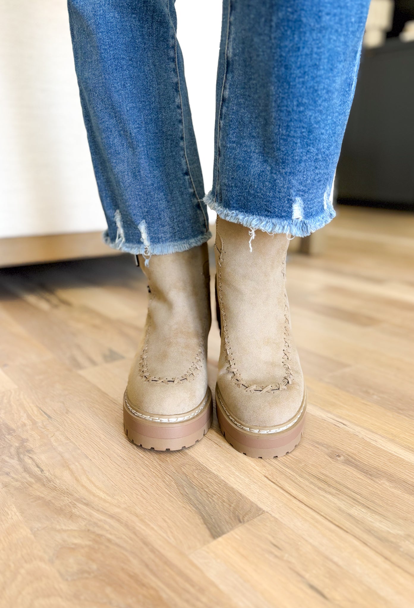 Toula Lug Sole Booties, taupe lug sole bootie with whip stitching around the whole boot, buckle on the top of the boot, wood and gum lug sole 