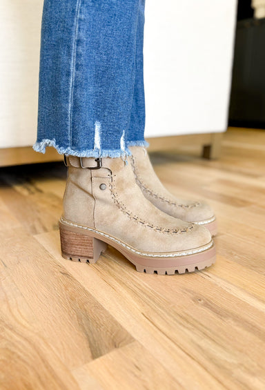 Toula Lug Sole Booties, taupe lug sole bootie with whip stitching around the whole boot, buckle on the top of the boot, wood and gum lug sole 