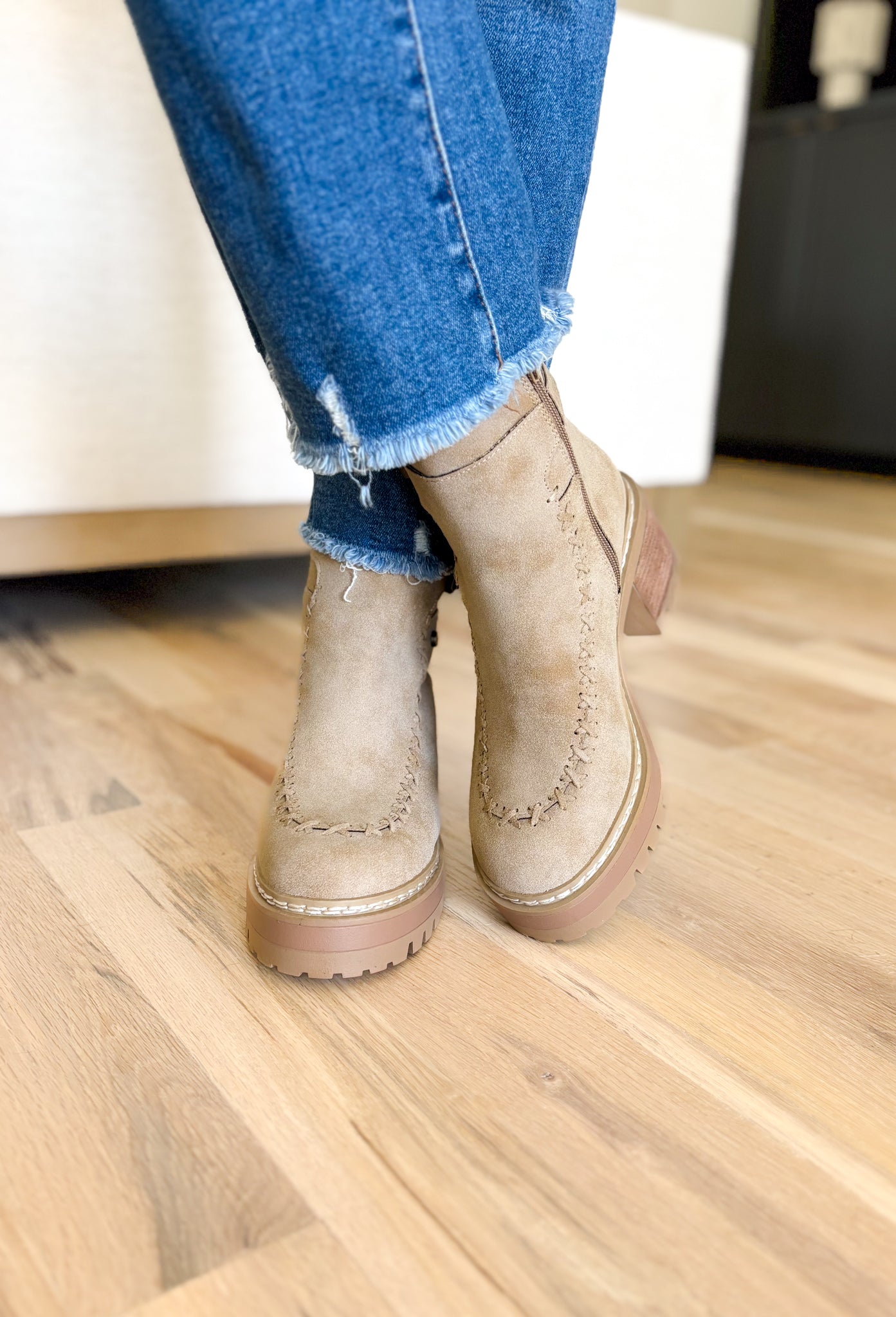 Toula Lug Sole Booties, taupe lug sole bootie with whip stitching around the whole boot, buckle on the top of the boot, wood and gum lug sole 