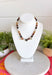 Warm earthy tones and shimmering details make this handcrafted necklace a standout accessory for every season! Featuring rich brown, and neutral beads accented with gold details, this chic piece is finished with sparkling heart-cut crystals that add just the right amount of sparkle. Whether you're dressing up a cozy sweater or adding a special touch to your favorite dress, this necklace is a timeless piece you'll reach for again and again.